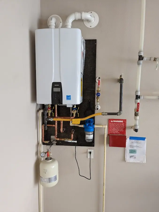 Professional plumber installing copper piping in a Woodland home